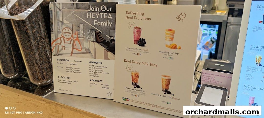 A menu board showcasing HEYTEA's fruit teas and milk teas, alongside a recruitment poster.