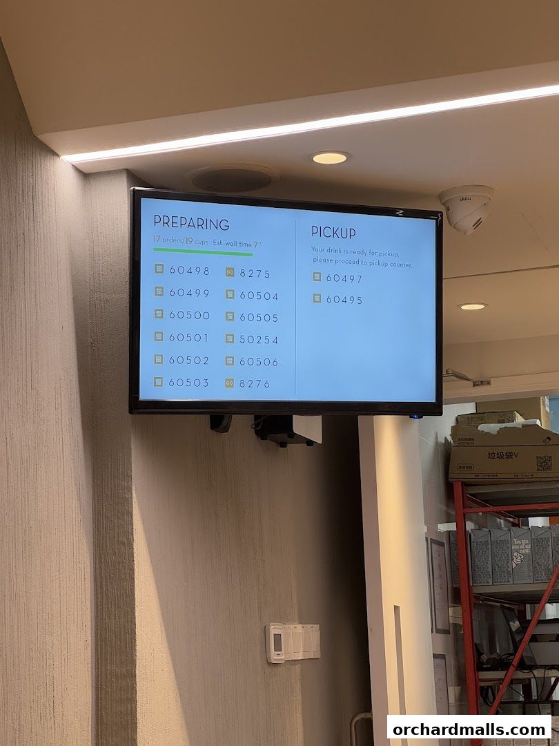 A digital screen displays order status with 'Preparing' and 'Pickup' sections.