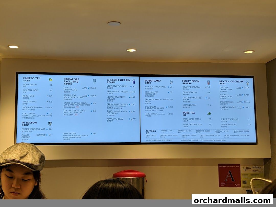 A digital menu board displaying various tea and ice cream options from HEYTEA.