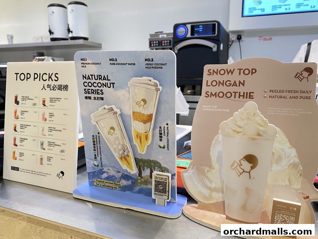 A display of popular drinks and menu items from HEYTEA, featuring smoothies and coconut-based beverages.