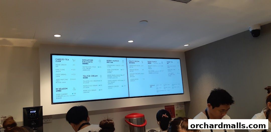 A digital menu board displaying various tea and ice cream options at HEYTEA.