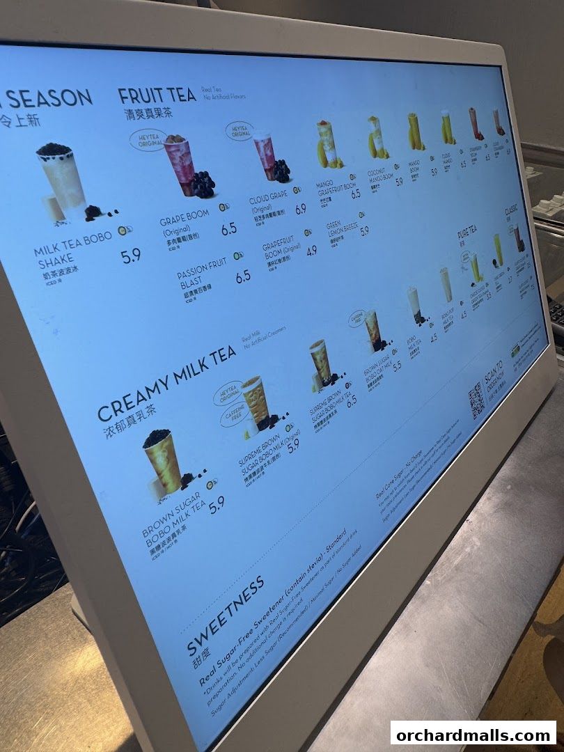 A digital menu displaying various fruit teas and milk teas with prices and images.