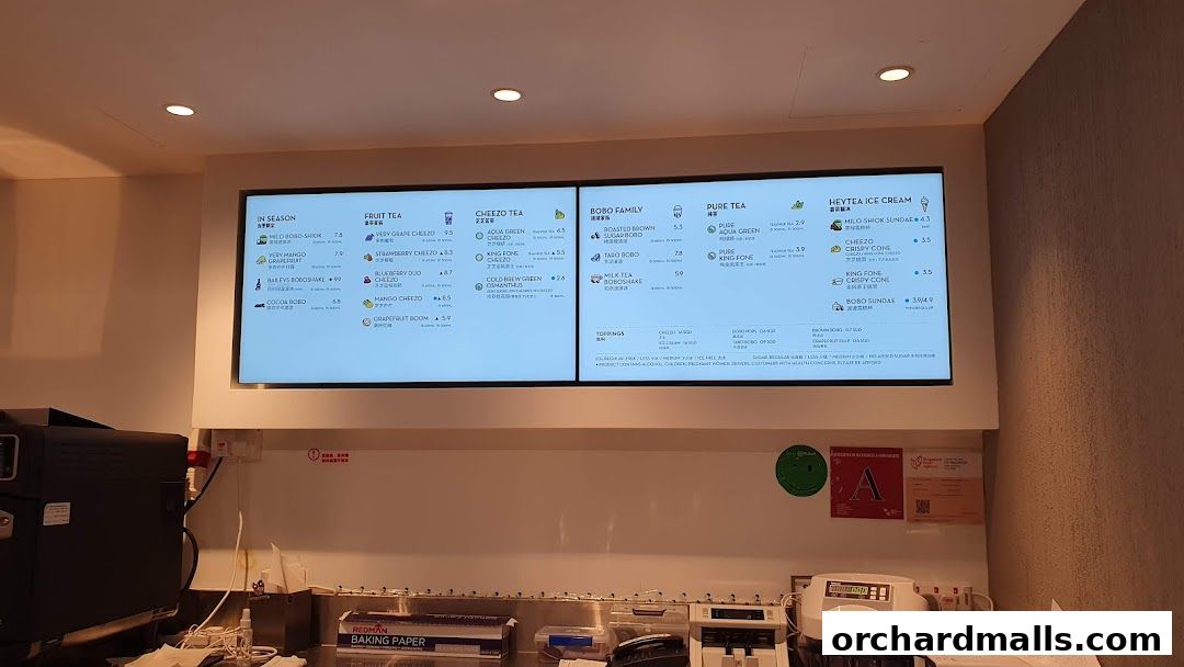 A digital menu board displaying various tea and ice cream options from HEYTEA.