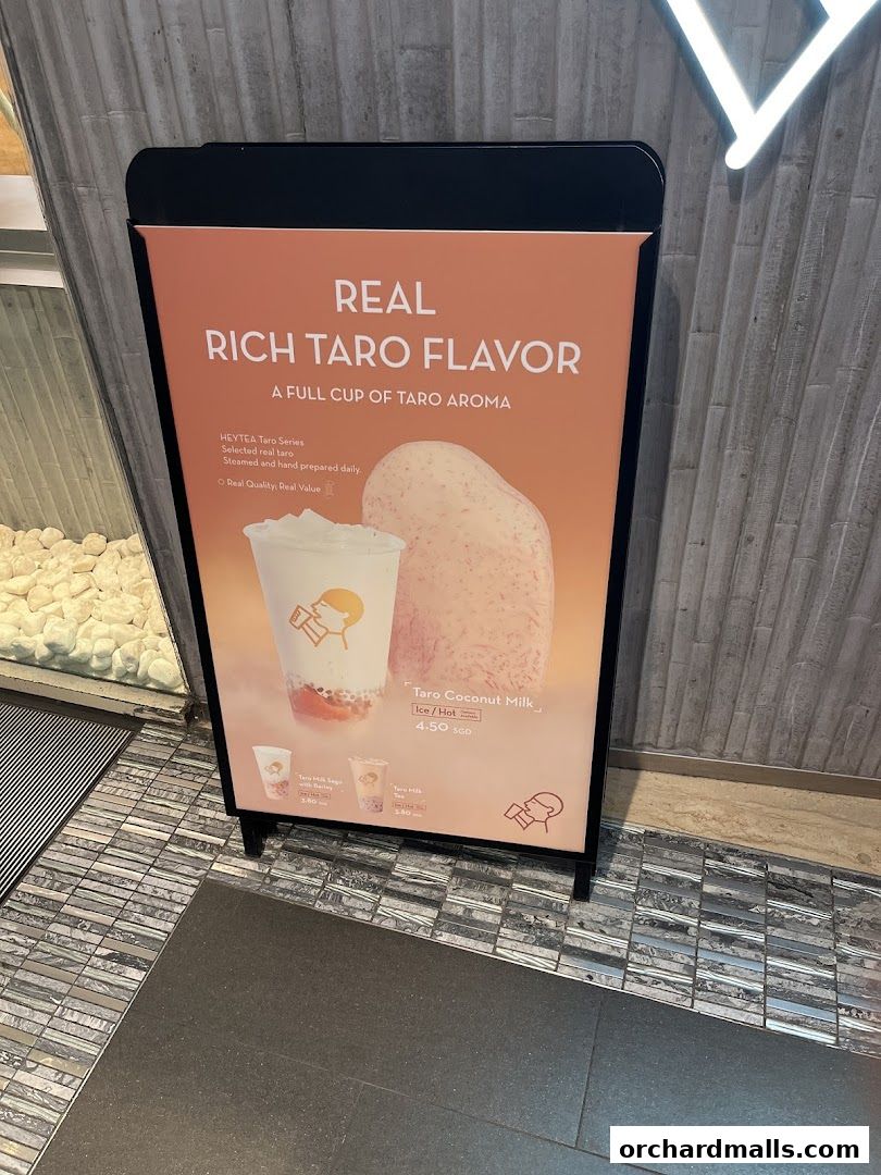 A sign advertising HEYTEA's Taro drinks, highlighting their rich taro flavor and quality ingredients.