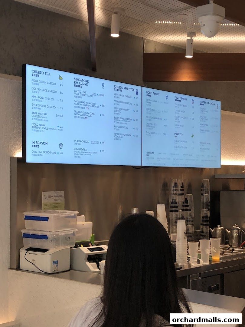 A digital menu board displaying various tea and beverage options at HEYTEA.