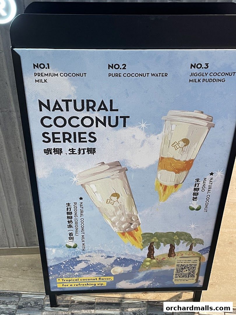A sign advertising HEYTEA's Natural Coconut Series with three featured drinks.
