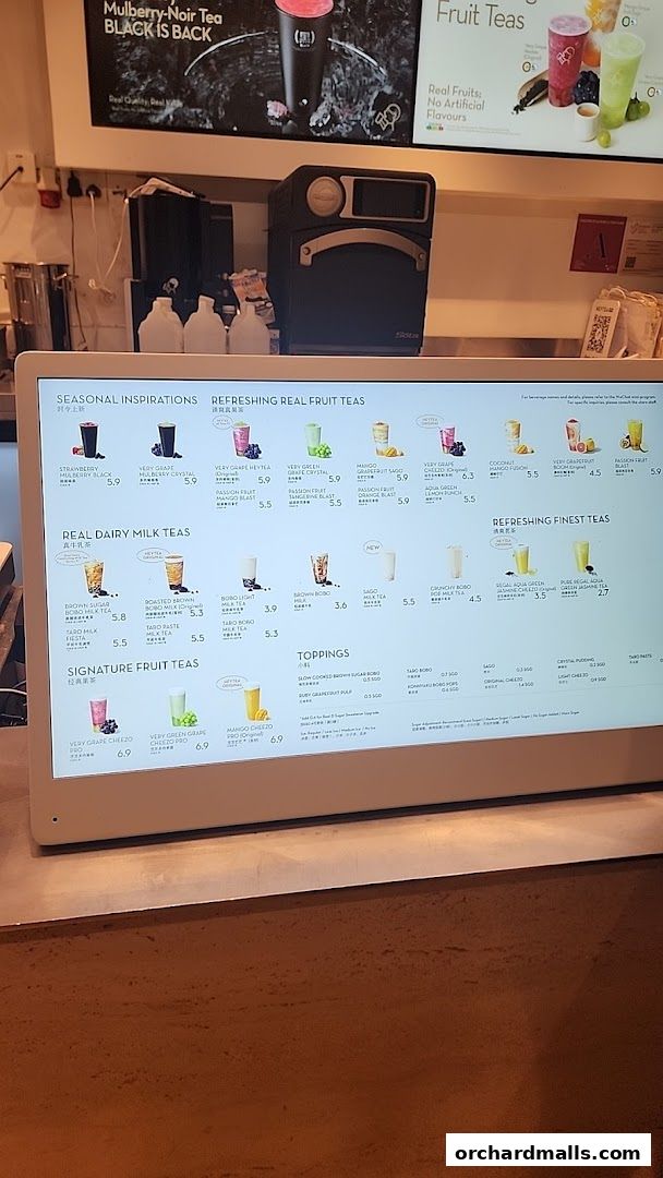 A digital menu displaying various fruit teas, milk teas, and toppings at HEYTEA.