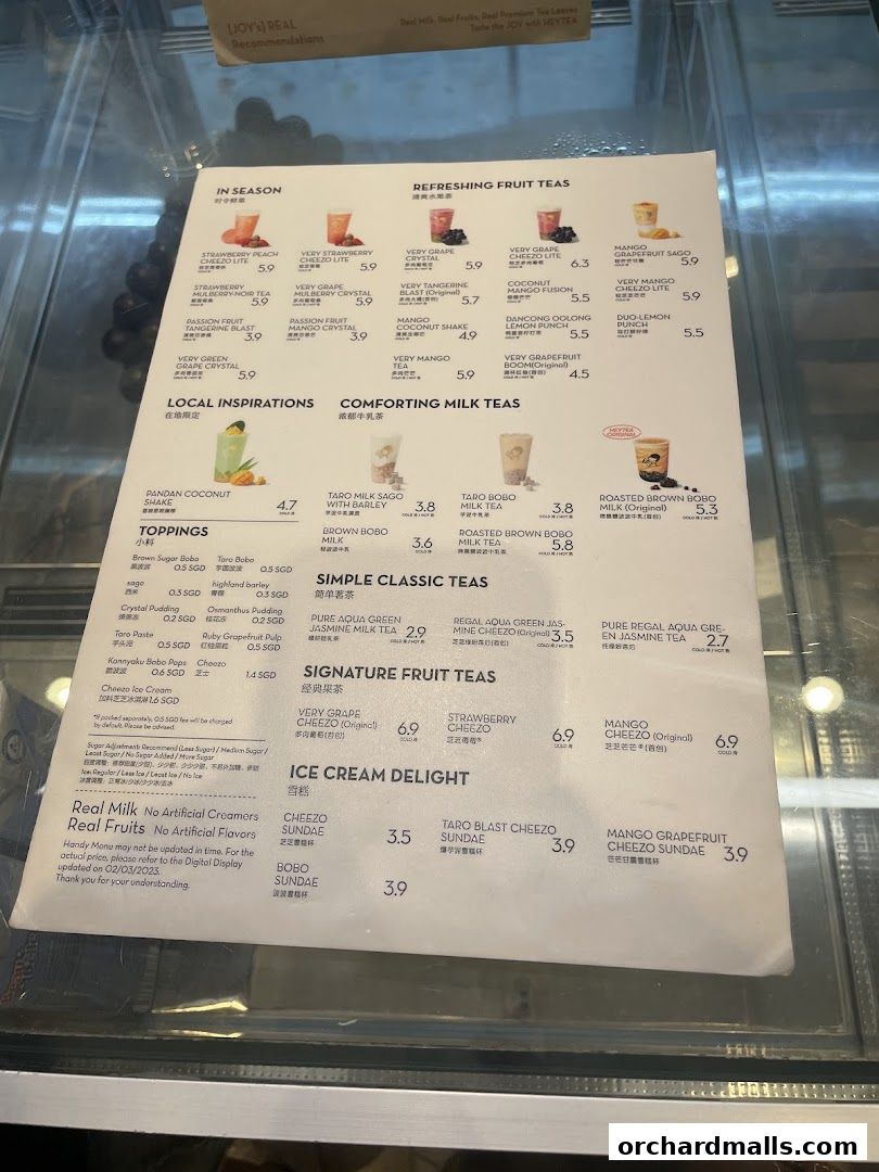 A menu from HEYTEA displaying various fruit teas, milk teas, and ice cream delights with prices.