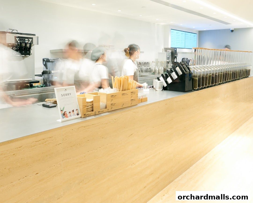 Interior shot of a HEYTEA shop with staff preparing drinks behind a counter.