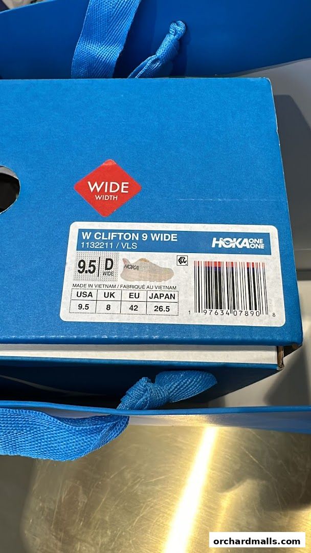 A Hoka One One shoe box showing size and model information.