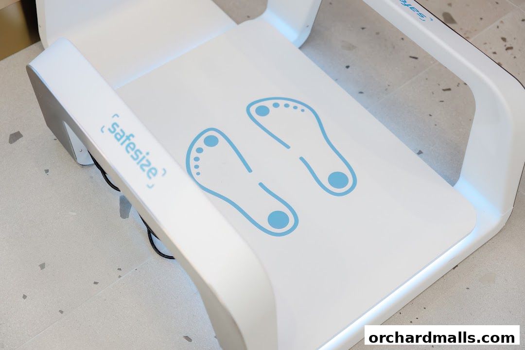A white Safesize foot scanning device with blue footprint icons.
