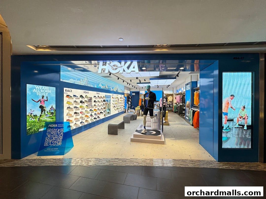 The HOKA Orchard store features a wide display of running shoes and apparel, with mannequins and promotional graphics.