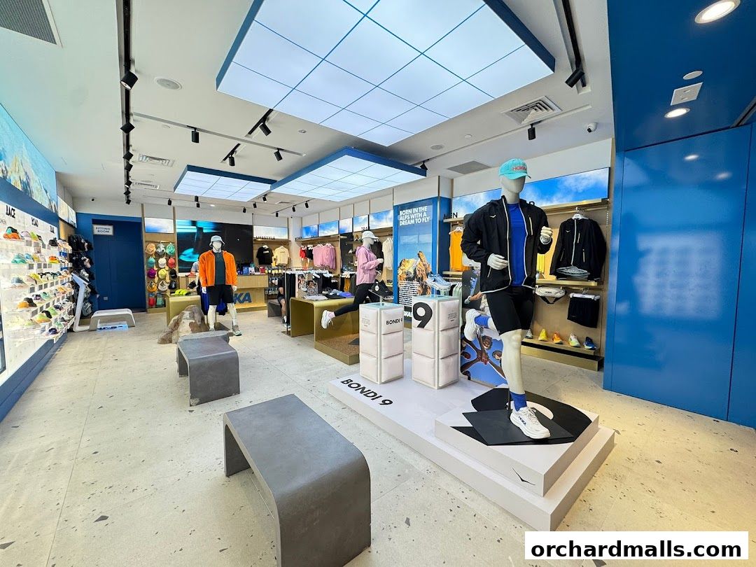 Interior view of a HOKA store showcasing athletic footwear and apparel with mannequins.