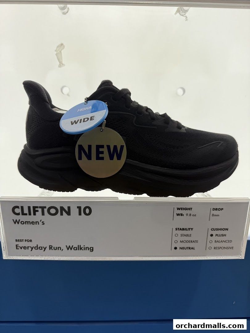 A black Hoka Clifton 10 women's running shoe with 'New' and 'Wide' tags.