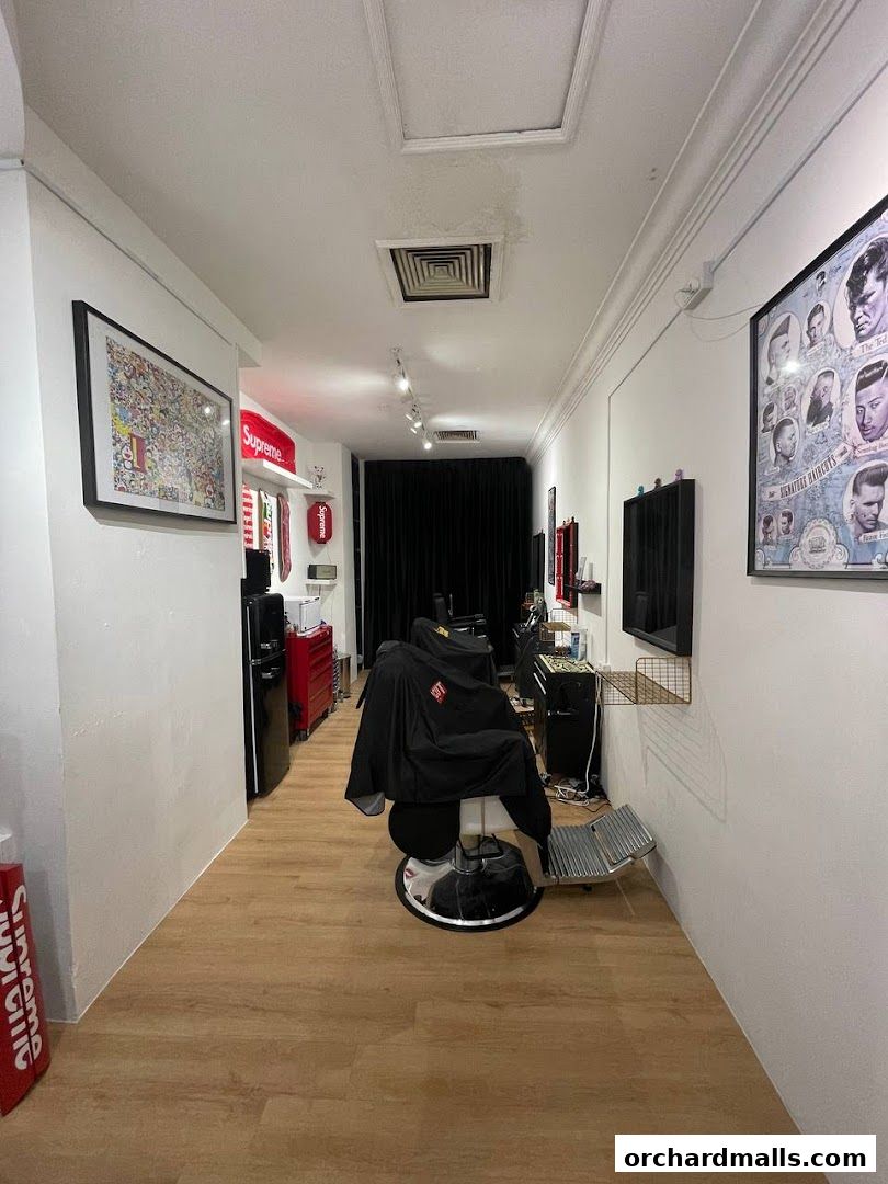 Interior view of a barbershop with barber chairs and styling equipment.