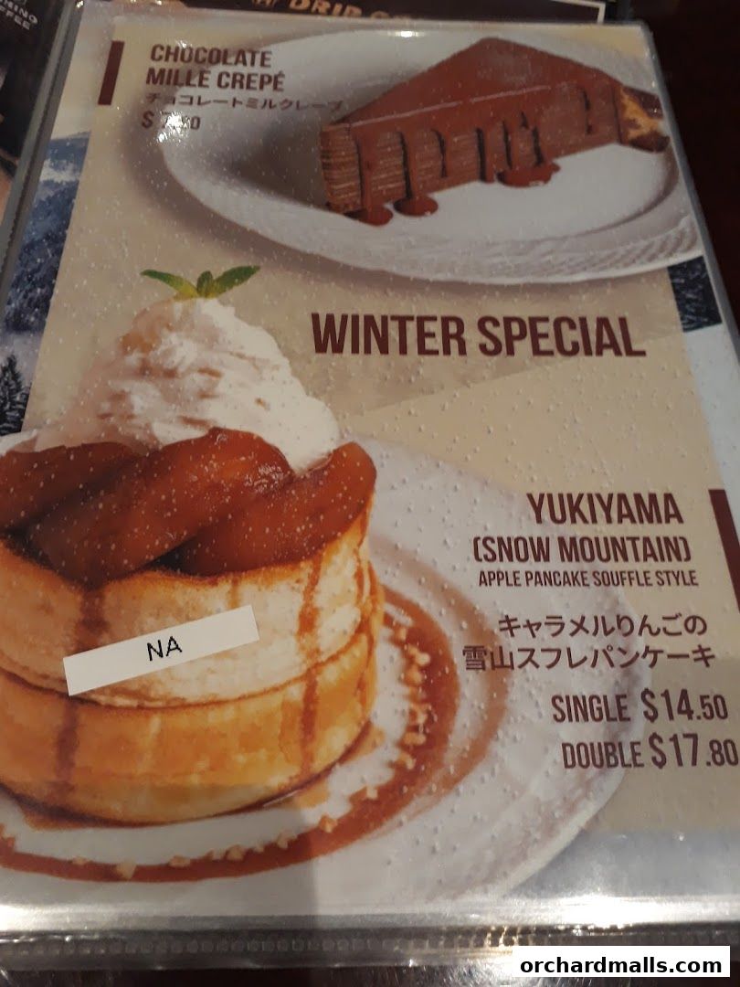 A menu featuring a chocolate mille crepe and a winter special apple pancake souffle.