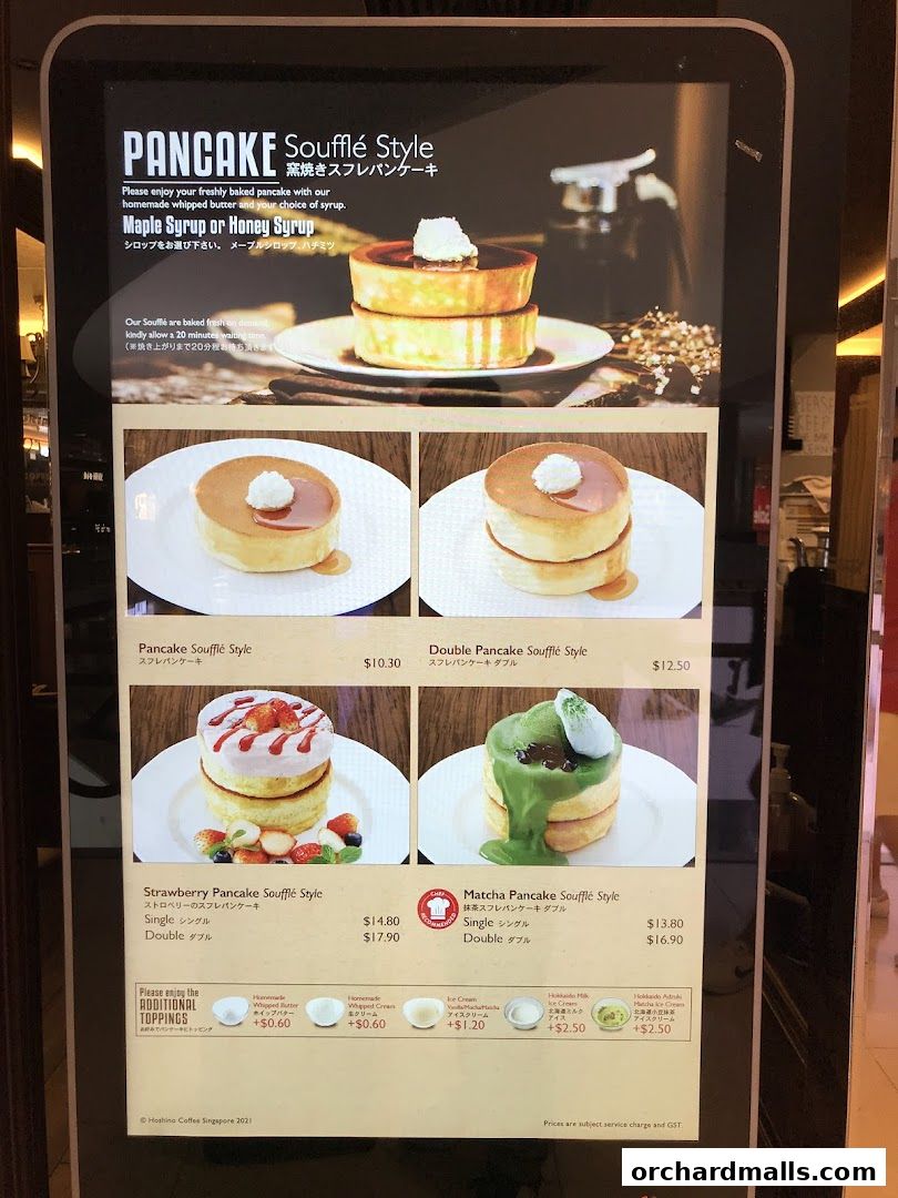 A digital menu displaying various soufflé pancake options with prices and toppings.