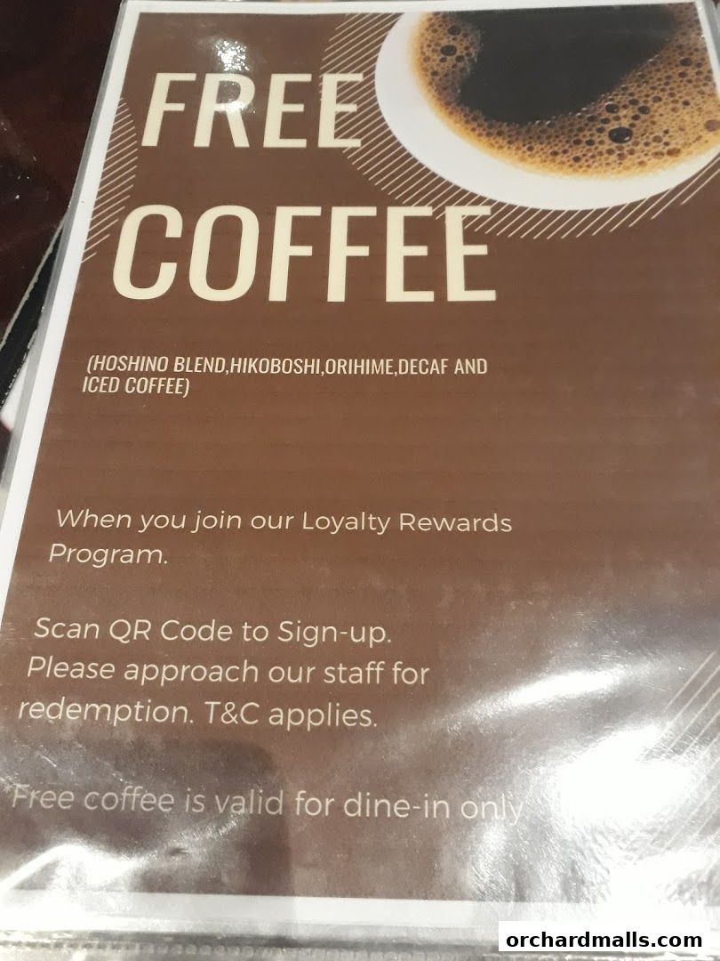 A sign advertising free coffee for loyalty program members at Hoshino Coffee.