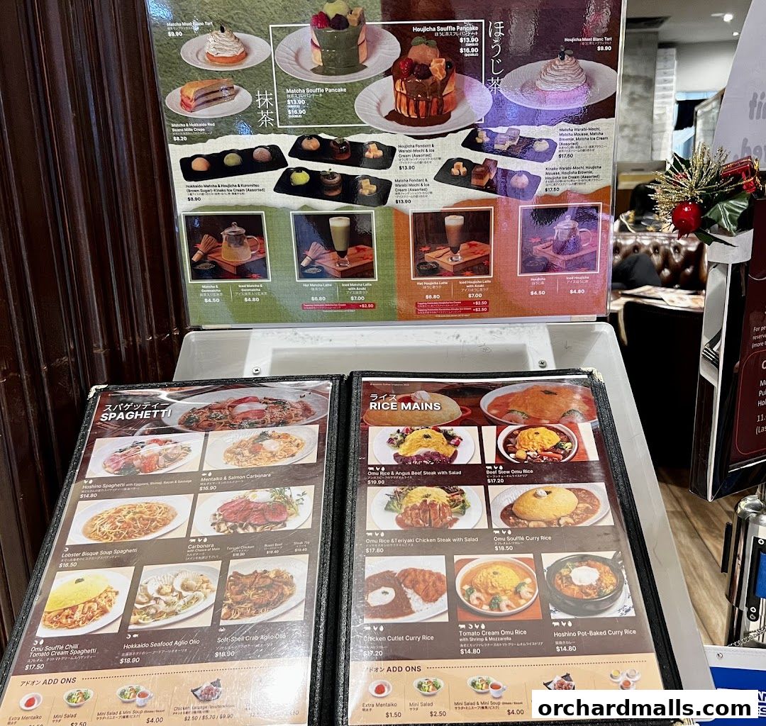 A menu display featuring various Japanese-inspired pasta, rice dishes, and desserts.