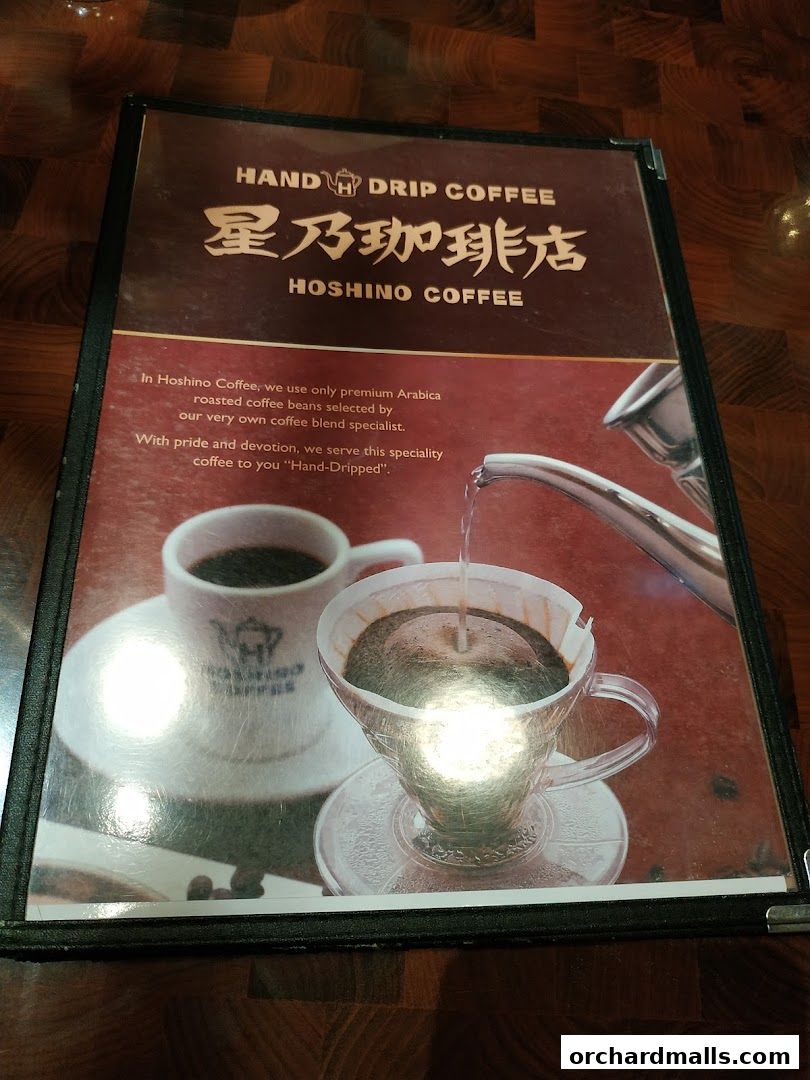 A menu cover for Hoshino Coffee showcasing hand-drip coffee preparation.