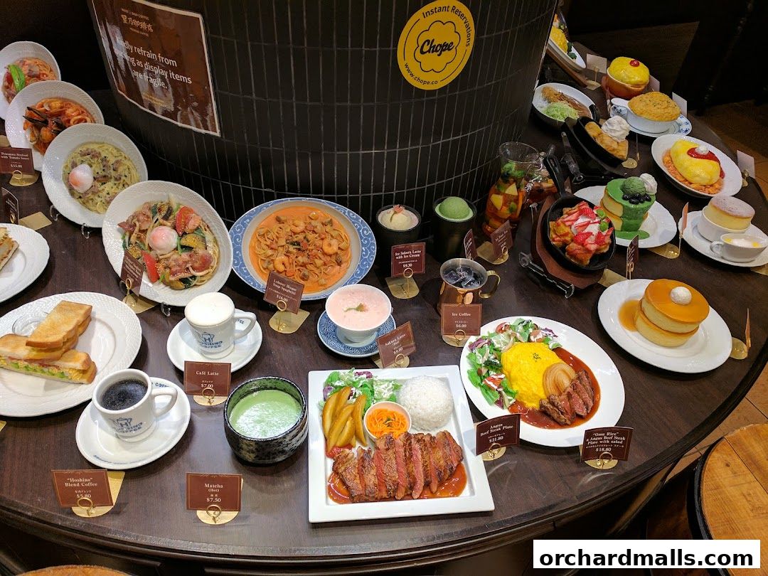 A display of various Hoshino Coffee dishes and drinks, including pasta, sandwiches, coffee, and desserts.
