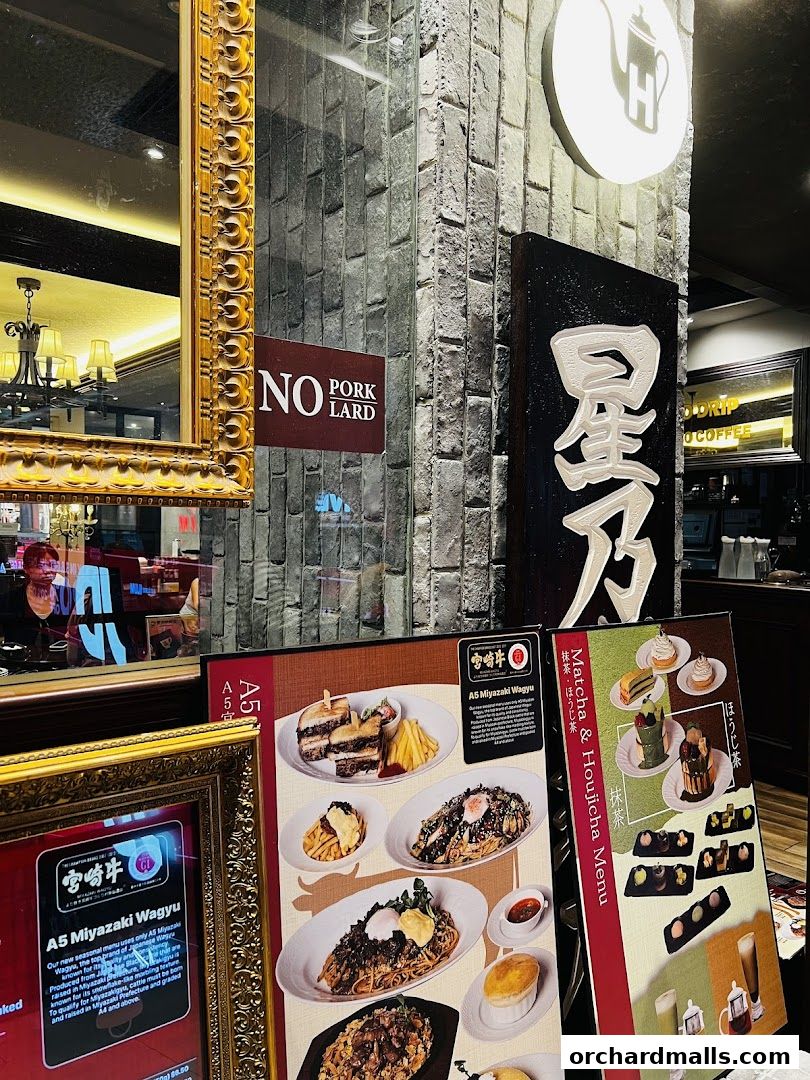 A display of food and drink menus outside Hoshino Coffee, featuring A5 Miyazaki Wagyu and Matcha & Houjicha items.