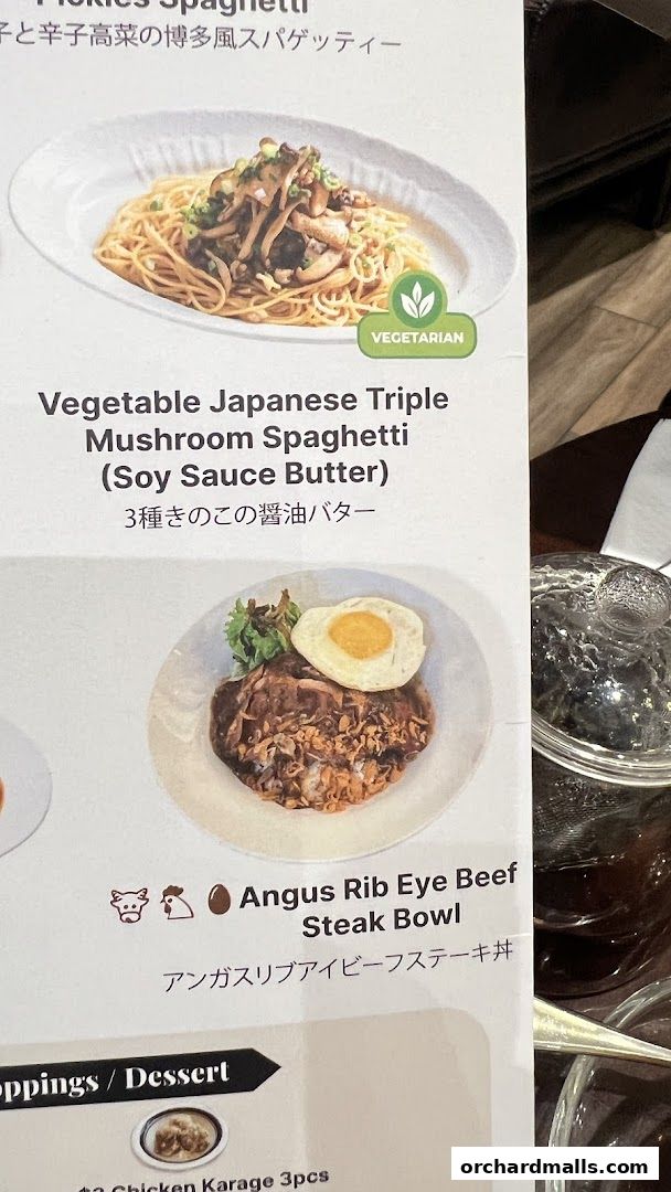 A menu featuring Japanese-style spaghetti and a steak bowl with a fried egg.