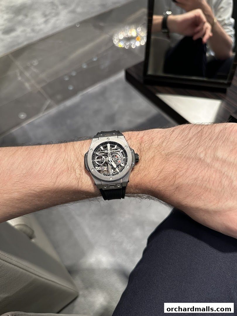 A close-up shot of a person wearing a Hublot watch on their wrist.