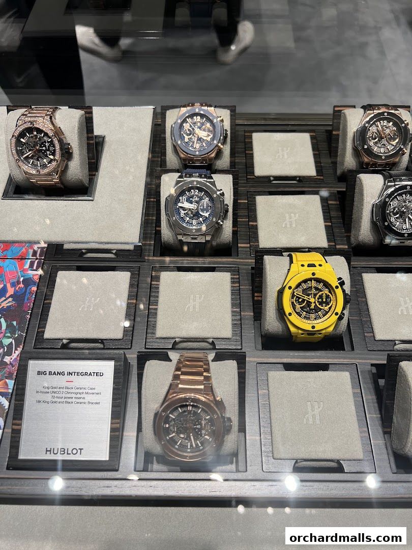 A display of luxury Hublot watches, including a rose gold model with diamonds and a yellow chronograph.