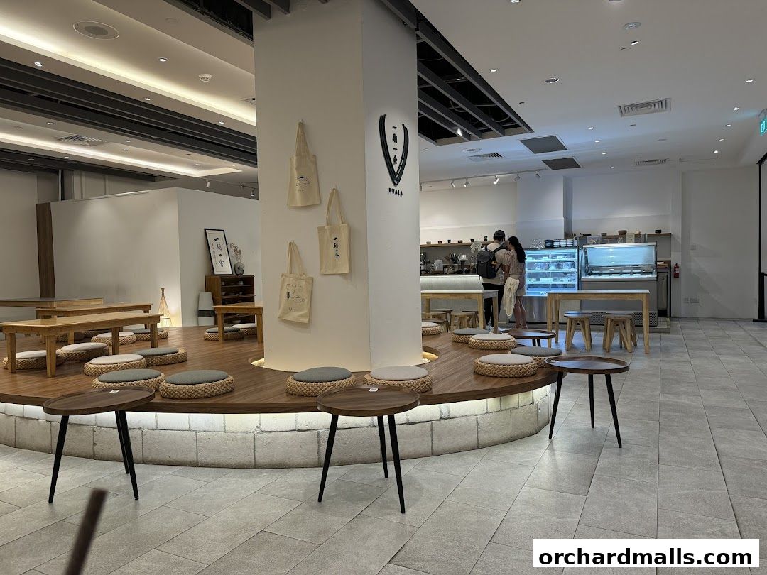 Interior of Hvala Takashimaya cafe with seating, counter, and display cases.