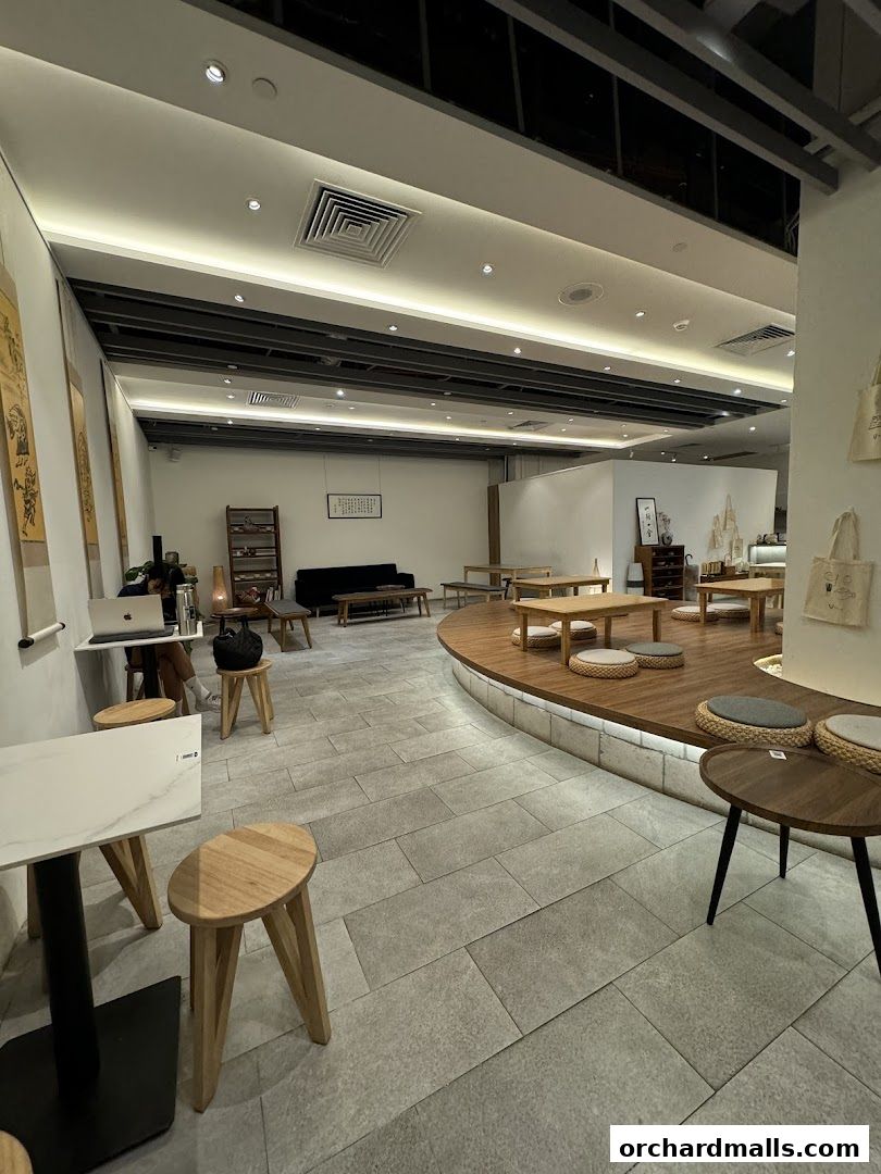 Interior view of Hvala Takashimaya cafe with seating areas and minimalist decor.