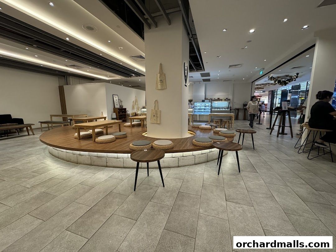 Interior view of Hvala Takashimaya cafe with seating and display cases.