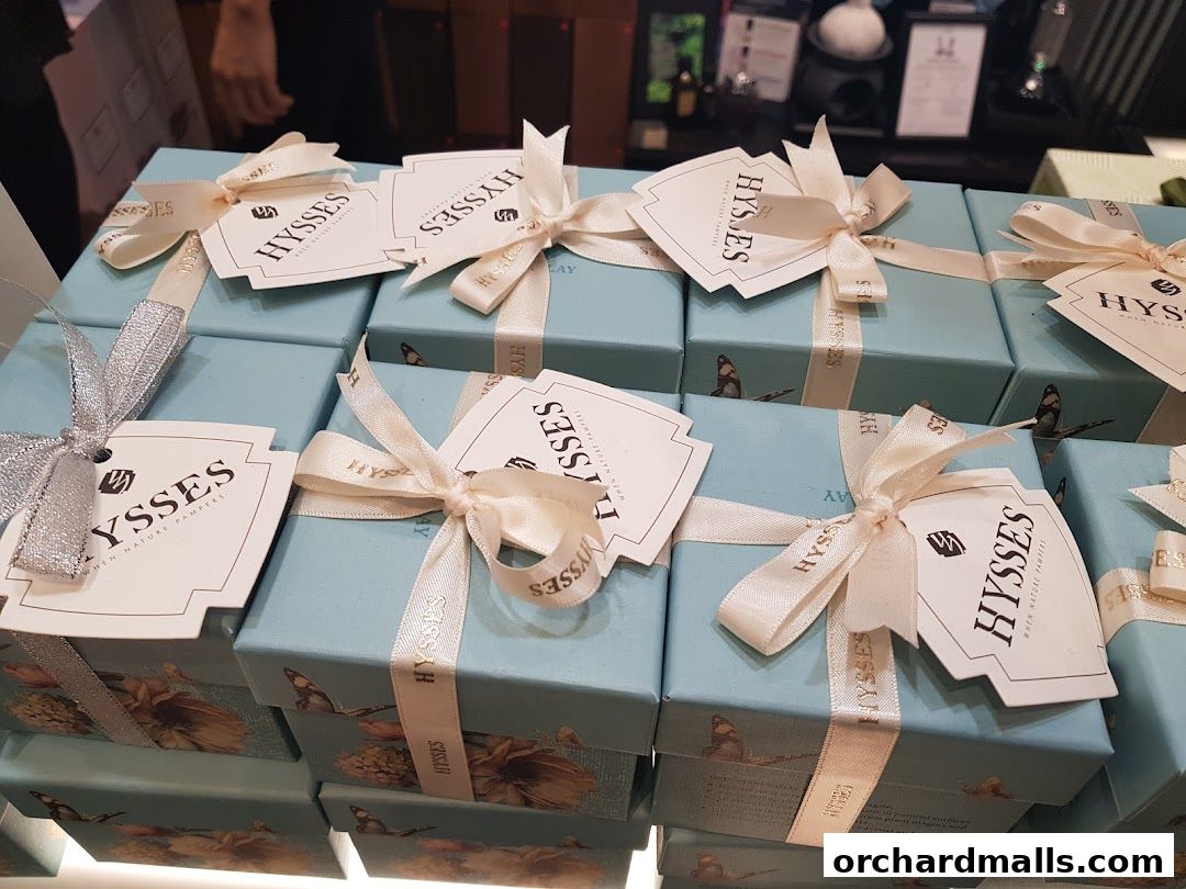 Neatly arranged gift boxes with ribbons and tags from HYSSES, an aromatherapy and essential oils shop.