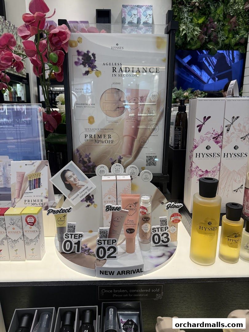 A display of HYSSES aromatherapy and essential oil products, featuring a new primer promotion.