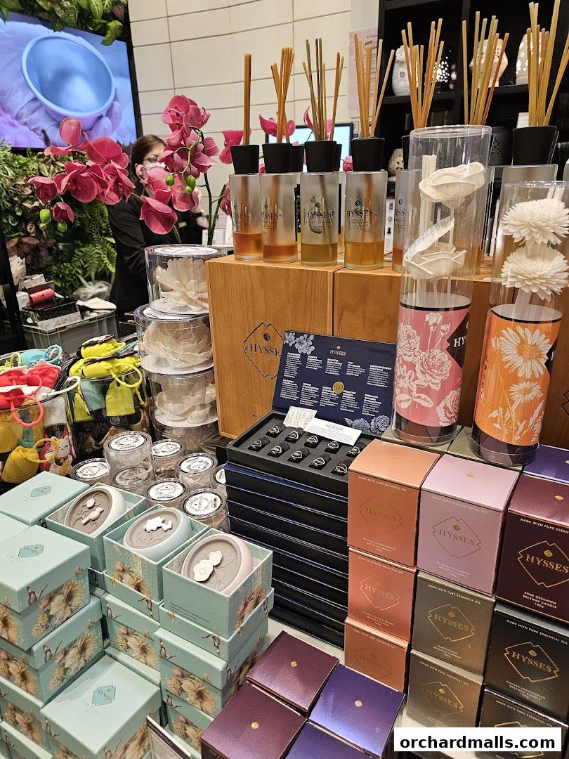A display of HYSSES aromatherapy products including reed diffusers, candles, and gift sets.