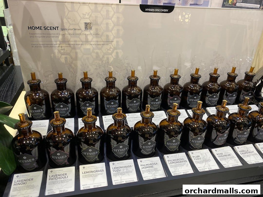 A display of amber glass bottles filled with essential oils, labeled with various scents.