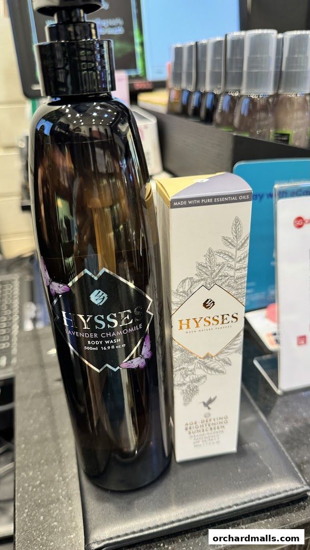 A bottle of Lavender Chamomile body wash and a box of Age-Defying Brightening Sunscreen from HYSSES.