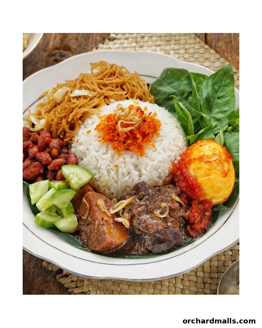 A delicious plate of Indonesian Nasi Campur with rice, meat, egg, vegetables, and crispy noodles.
