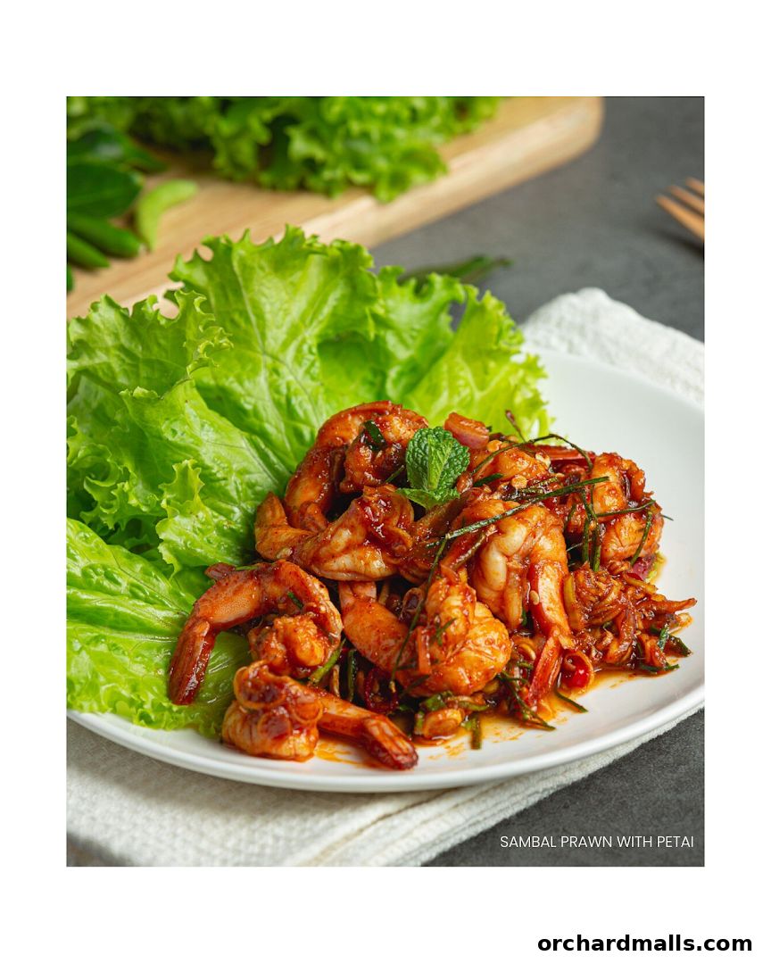 A plate of sambal prawn with petai served with fresh lettuce.