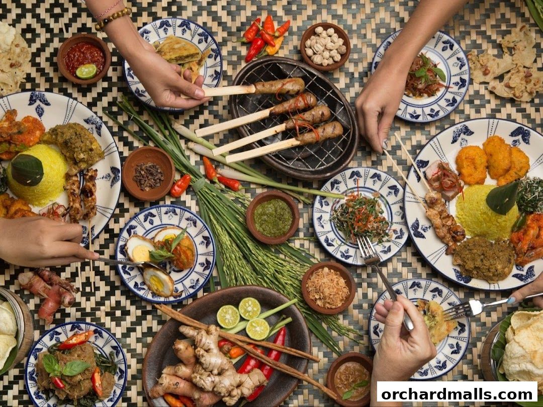 A spread of Indonesian dishes, including satay, rice, and various side dishes, being enjoyed by diners.