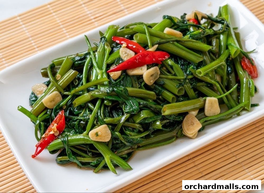 A plate of stir-fried water spinach with chili and garlic.