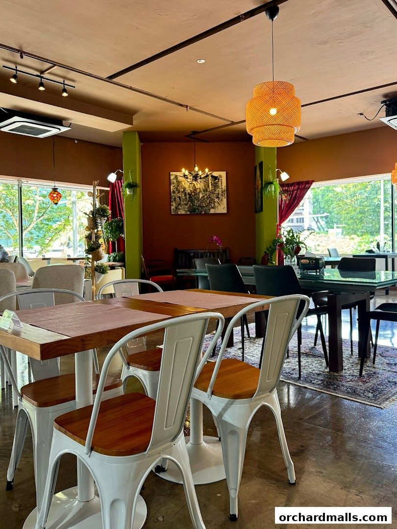 Interior of a restaurant with tables, chairs, and decorative lighting.