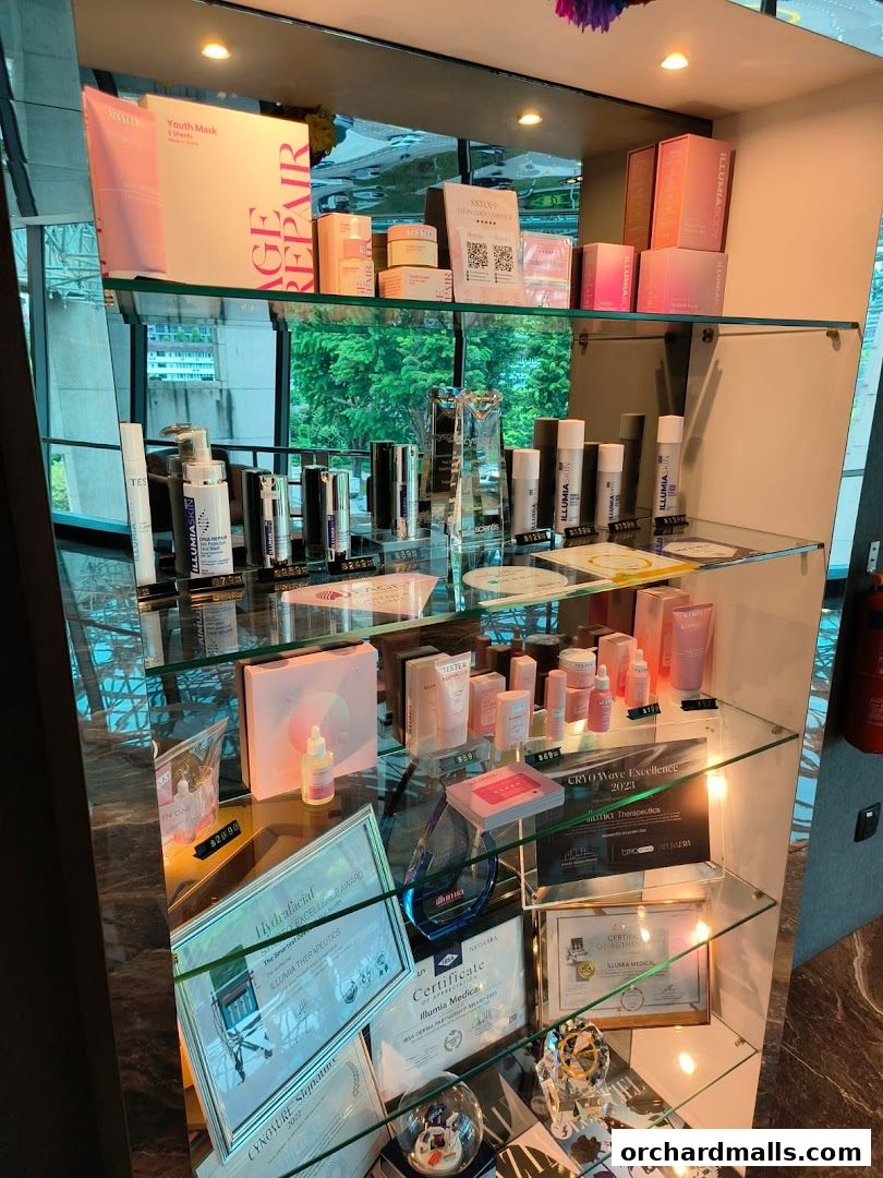 A display case filled with skincare products, awards, and certificates from Illumia Therapeutics.