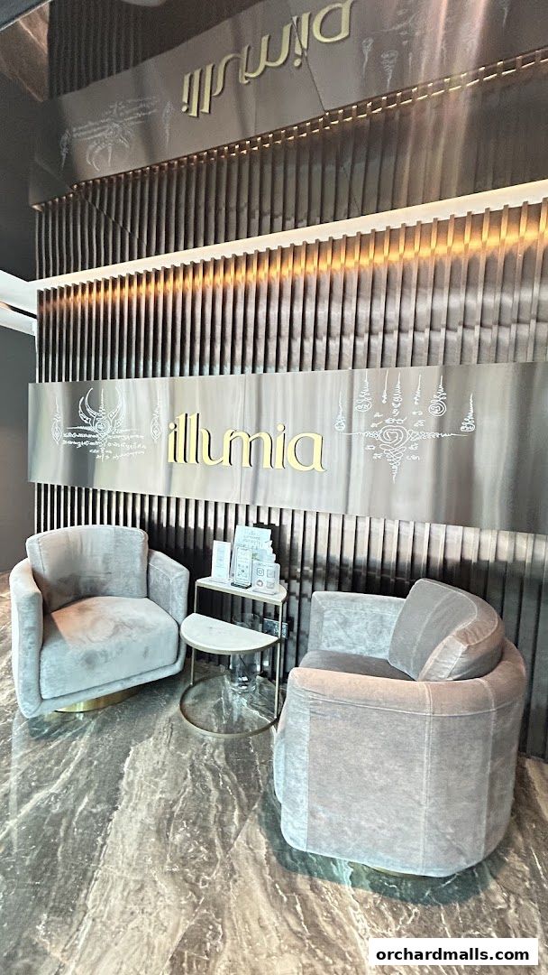 Luxurious waiting area with plush chairs and the 'illumia Therapeutics' logo.