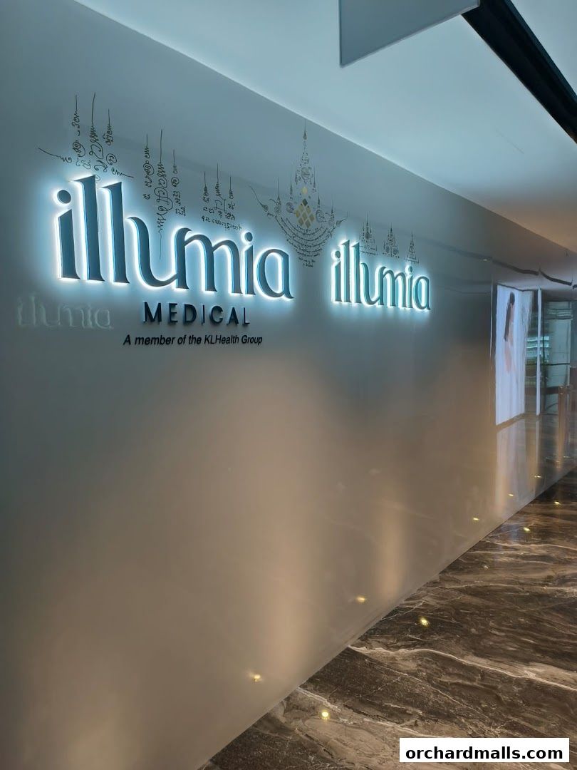 Illumia Therapeutics Medical Spa logo illuminated on a wall with decorative script.