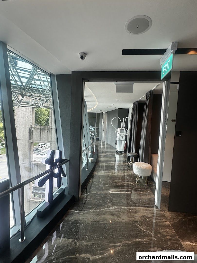 Interior hallway of a modern medical spa with marble floors and treatment equipment.