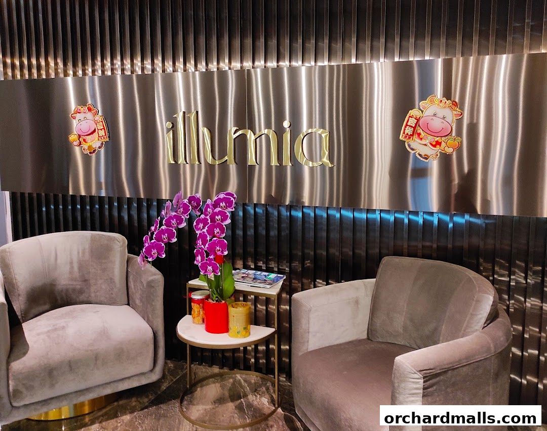 A luxurious waiting area with plush chairs and the 'illumia Therapeutics' logo.