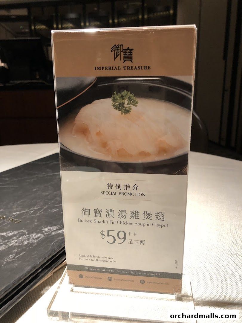 A menu stand displays a special promotion for Braised Shark's Fin Chicken Soup.