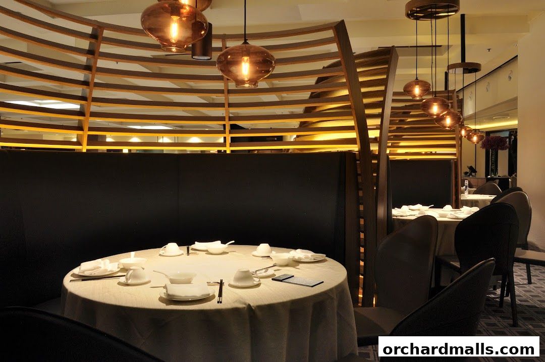 Elegant dining area with round tables set for a meal, featuring warm lighting and modern decor.