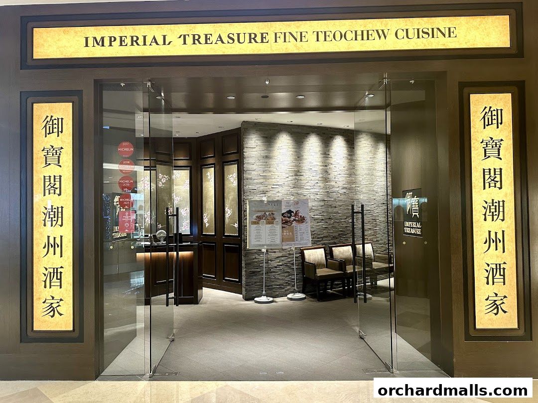 The entrance to Imperial Treasure Fine Teochew Cuisine, featuring elegant signage and glass doors.